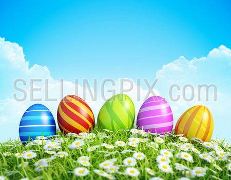 Easter Greeting Card with decorated Easter eggs in the grass with flowers. Background with ornate Easter eggs on meadow.