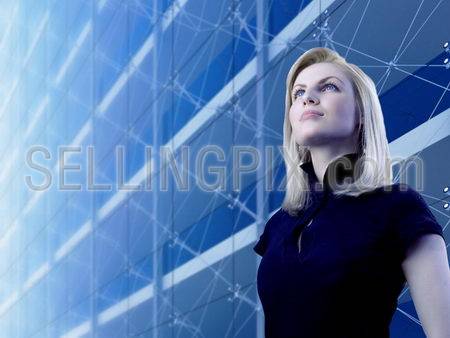 Attractive blonde standing by the skyscraper (outstanding business people in interiors / interfaces series)