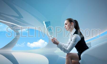 Sexy businesswoman examining future digital report / newspaper (outstanding business people in interiors / interfaces series)
