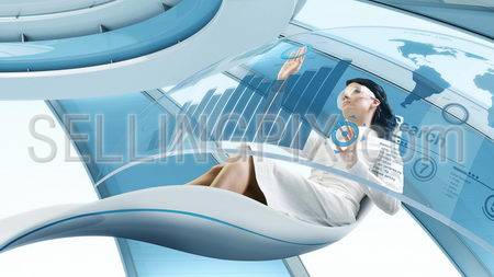 Future lifestyle. Sexy brunette sits in the futurisctic armchair. Working with transparent touch screen interface. Concept of computer operator workplace in the future / space ship or another planet.